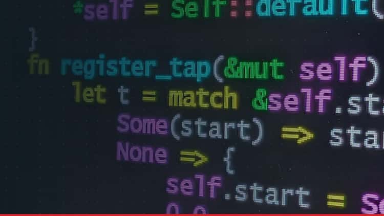 Colourful program code glowing on a dark screen